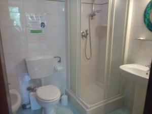 a bathroom with a shower and a toilet and a sink at Soggiorno Petrarca in Florence