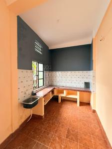 a bathroom with a bench and a sink at Ghar Homestay in Silchar