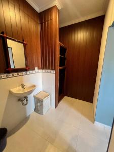 a bathroom with a sink and a mirror at Varmana Ubud - The Blue House in Ubud