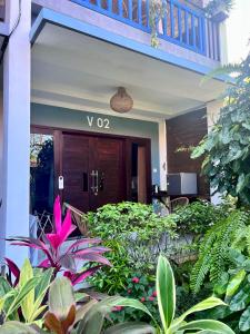 a front door of a building with plants at Varmana Ubud - The Blue House in Ubud +4 photos