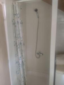 a shower in a bathroom with a shower curtain at Domek u rodinného domu in Hradec Králové