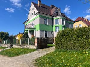 a large house with a green and white at Vila Šebest in Volary