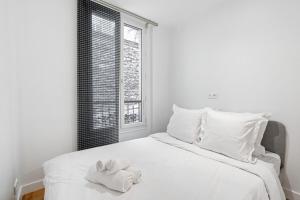 Postel nebo postele na pokoji v ubytování Montmartre - Élégance & Charme au pied Sacré-Cœur