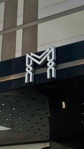 a hilton sign on the side of a building at Artama Hotel in Unayzah
