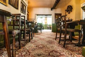 an empty room with chairs and tables in a restaurant at Community Owned Gwesty Owain Glyndwr Hotel in Corwen