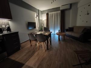 a living room with a table and chairs and a couch at Olympus House in Litochoro
