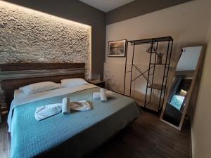 a bedroom with a bed with towels on it at Olympus House in Litochoro