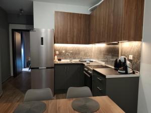 a kitchen with a refrigerator and a table and chairs at Olympus House in Litochoro