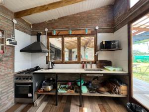 a kitchen with a sink and a stove at Zafarrancho Zárate in Zárate