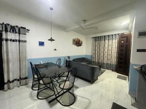 a living room with a table and chairs and a couch at The Glory Villa Transit Hotel in Katunayaka