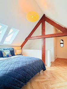 a bedroom with a bed and a vaulted ceiling at Cooth's Luxury Loft with City Views in Breda