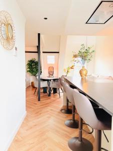a dining room with a table and chairs at Cooth's Luxury Loft with City Views in Breda