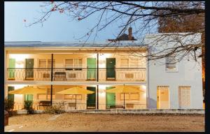 a large white building with umbrellas in front of it at Little Mod Hotel at the University in Charlottesville