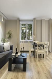 a living room with a couch and a table at Elite Apartments Old Town Center in Gdańsk