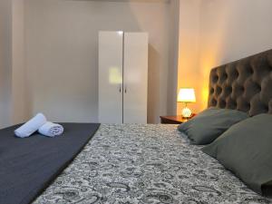 a bedroom with a large bed with a headboard and pillows at House Alexandros in Neos Marmaras +17 photos