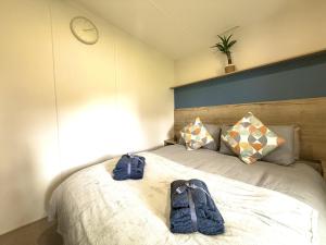 a bedroom with a bed with a clock on the wall at The Bay in Filey