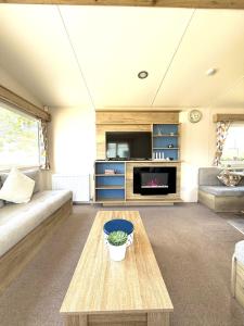 a living room with a couch and a table at The Bay in Filey +90 photos