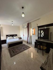 a large bedroom with a bed and a piano at BERGHOFF RESIDENCE - LUXURY AIR- CONDITION VILLA WITH PRIVATE POOL - king Marriott Alex in Alexandria +47 photos