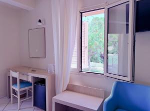 a room with a desk and a window at Princess Hotel in Lassi