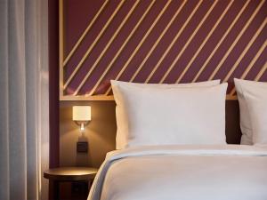 Postel nebo postele na pokoji v ubytování B&B HOTEL Aachen City-Ost + 19 fotografií