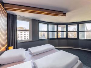 Postel nebo postele na pokoji v ubytování B&B HOTEL Aachen City-Ost