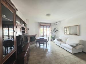 a living room with a white couch and a table at AXIS Apartments Terni Essence in Terni