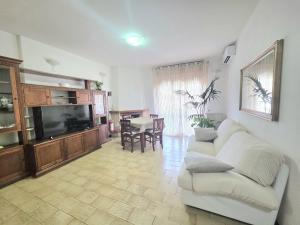 a living room with a couch and a tv at AXIS Apartments Terni Essence in Terni