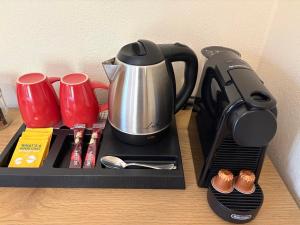 a tray with a coffee maker and a tea kettle at Sun Touch Pelion Rooms in Kala Nera