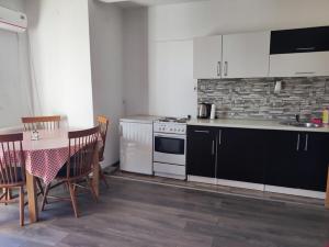 a kitchen with a table and a stove top oven at Vela-edo in Zavidovići