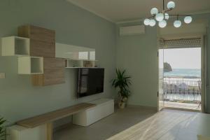 a living room with a flat screen tv on a wall at La voce del mare in Agropoli