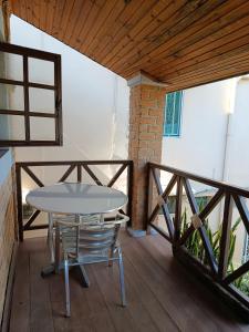 a table and chairs on a porch with a wooden deck at Hotel Mahamanina in Fianarantsoa
