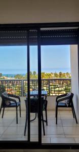 a view of a balcony with a table and chairs at البحر والشمس والطبيعه in Pont Blondin