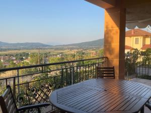 a table and chairs on a balcony with a view at Volvi View Apartment in Néa Mádhitos