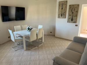a dining room with a white table and chairs at Flaminia guesthouse in Rignano Flaminio