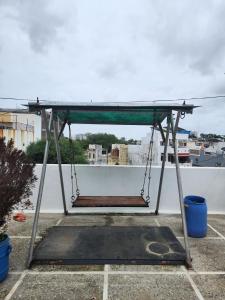 a swing set on top of a roof at dwarika home stay ujjain in Ujjain