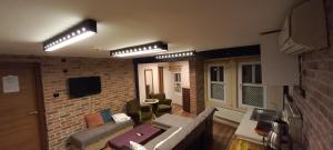 a living room with a couch and a brick wall at Coskun apt in Istanbul