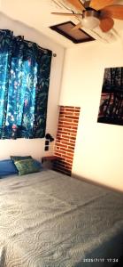 a bedroom with a bed and a ceiling fan at Spacieux T2 à deux pas de la mer in Collioure