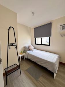a bedroom with a bed with a ladder and a window at Cozy Scandi Industrial House in San Pablo +9 photos