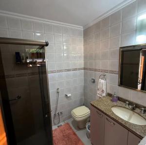 a bathroom with a toilet and a sink and a shower at Casa Klippel in Petrópolis