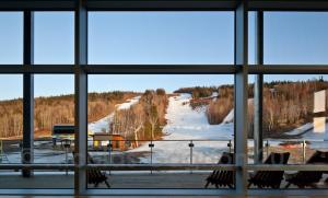 a view from a window of a snow covered field at Hébergement Parc du Mont Saint-Mathieu in Saint Mathieu de Rioux