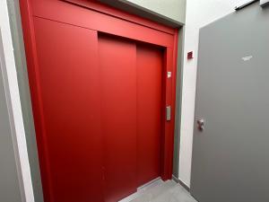a red elevator door in a building at Ferienwohnungen Vito's Apartments Ravensburg in Ravensburg
