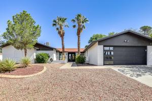 a house with a garage and palm trees at El Paso Oasis Near Franklin Mountains State Park in El Paso