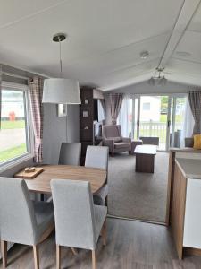 a dining room with a table and chairs at Northern Lights in Lossiemouth