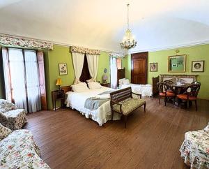 sypialnia z dwoma łóżkami, stołem i krzesłami w obiekcie Villa Bernardino Galliari w mieście Andorno Micca