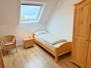 Ένα ή περισσότερα κρεβάτια σε δωμάτιο στο Cosy Holiday Nest in Marienhafe