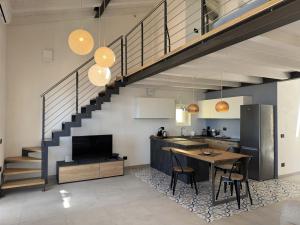 a kitchen and dining room with a staircase in a house at Casina di Nonna Meca by Solturelba in Capoliveri