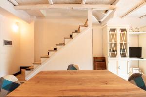a dining room with a wooden table and stairs at La Perla di Livata in Livata