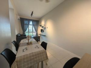 a dining room with a long table and chairs at Ipoh Town 2224 six pax By Hopestay in Ipoh