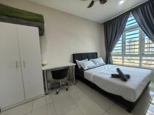 a bedroom with a bed and a desk and a window at Ipoh Town 2224 six pax By Hopestay in Ipoh +25 photos