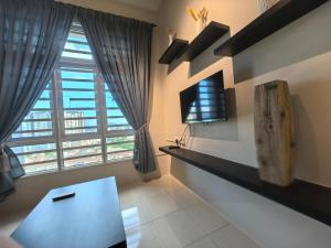 a living room with a table and a large window at Ipoh Town 2224 six pax By Hopestay in Ipoh